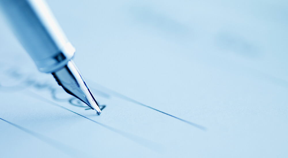 Blue-washed close up of fountain pen nib writing